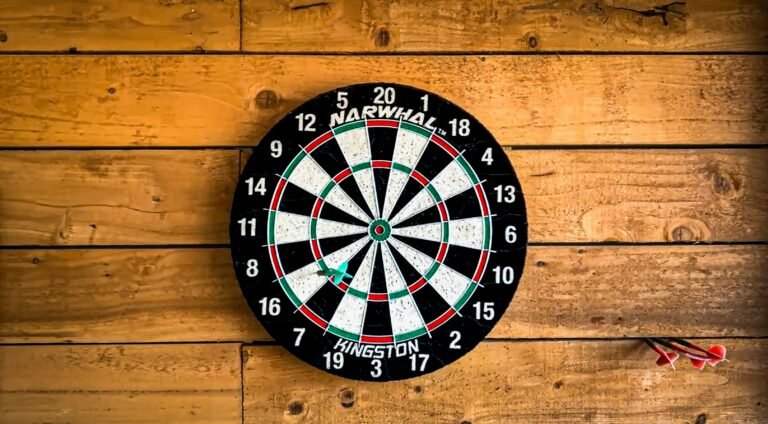 Image of a dartboard against a wooden wall